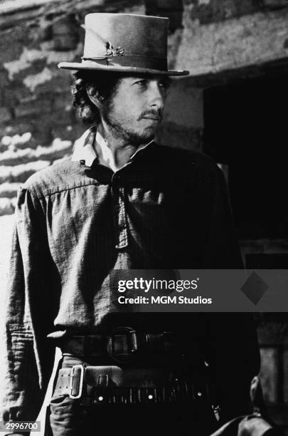 American singer and songwriter Bob Dylan wears a stovepipe hat in a still from the film western, 'Pat Garrett & Billy The Kid' directed by Sam...