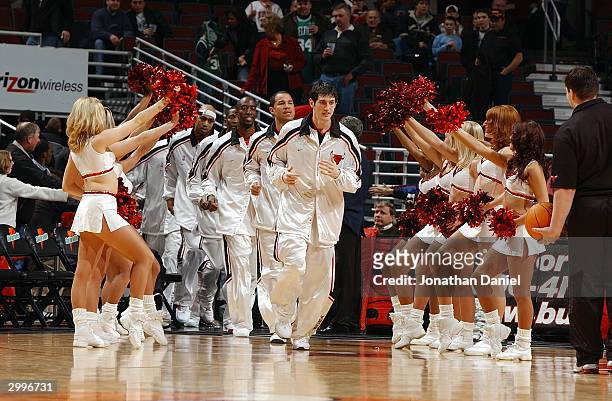 As the Luvabulls cheer, Kirk Hinrich leads the Chicago Bulls onto the court for the game against the Boston Celtics at the United Center on February...
