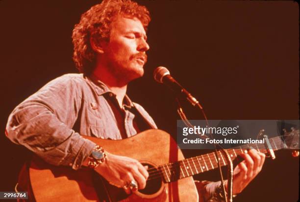 Canadian folk-rock singer and songwriter Gordon Lightfoot sings and plays acoustic guitar for the television concert series, 'Midnight Special,'...