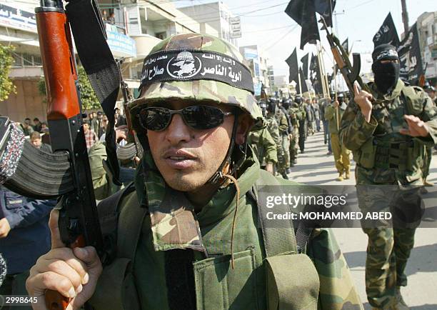 Armed members of the Popular Resistance Committees demonstrate 20 February 2004 in Gaza City against the arrest of four of their comrades who were...