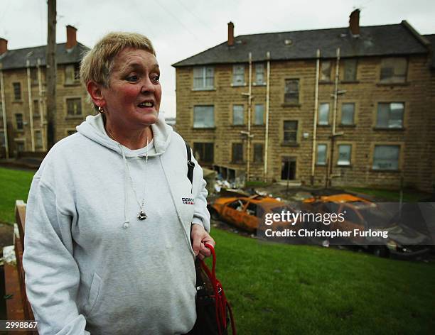 Frances Spence, who says she suffers from the constant dampness in her home, walks through Possil Park February 20, 2004 in Glasgow, Scotland. The...