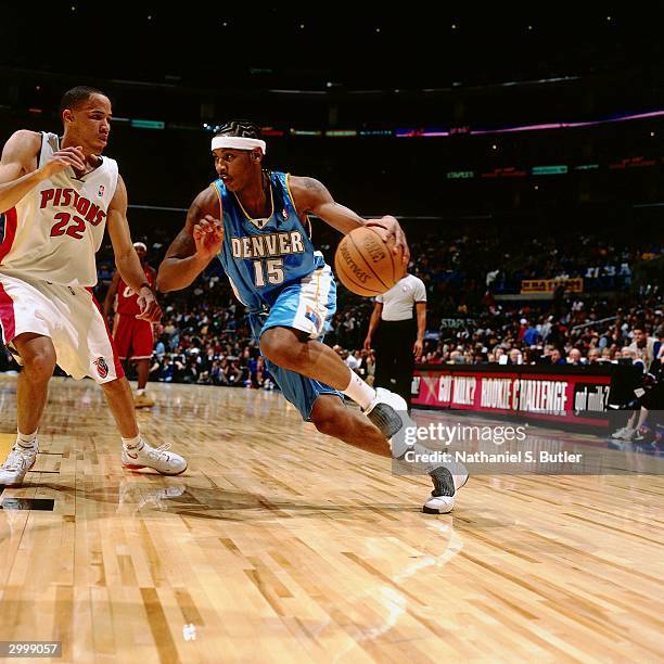 Carmelo Anthony of the Rookie Team drives against Tayshaun Prince of the Sophomore Team during the got milk? Rookie Game on February 13, 2004 at...