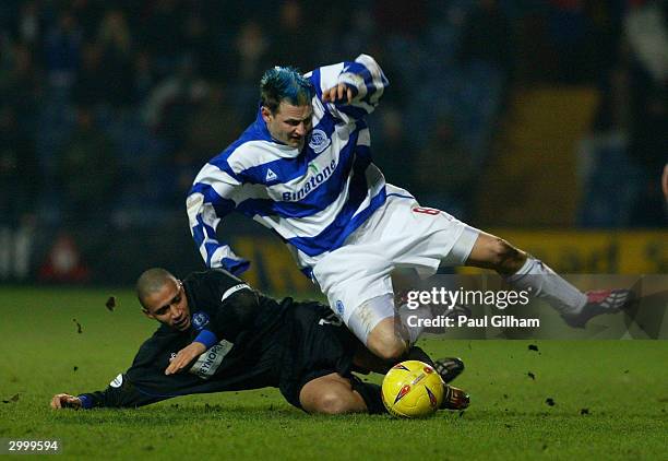 Marc Bircham of Queens Park Rangers is tackled by Curtis Woodhouse of Peterborough United during the Nationwide Second Division match between Queens...