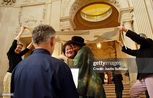 Lesbian couple hugs after being married in the rotunda of San Francisco City Hall February 20, 2004 in San Francisco, California. San Francisco...