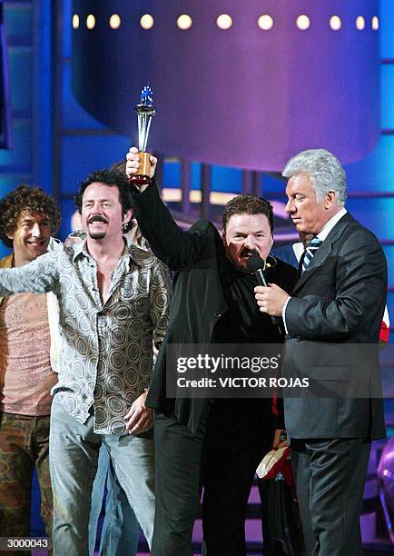 Bobby Kimball , singer of the rock and pop band Toto holds "The Torch", an award given to the group during the 45th edition of the Vina de Mar...