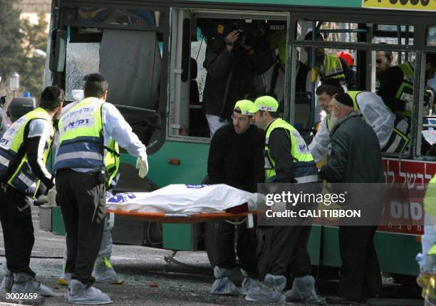 Body is evacuate by Ultra-Orthodox volunteers after a Palestinian suicide attack on an Israeli bus in the center of Jerusalem 22 February 2004 .A...