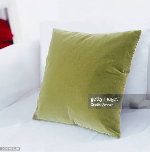 green cushion on sofa - cushion stock pictures, royalty-free photos & images
