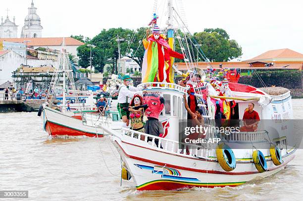 Revelers belonging to the Fofo de Belem Carnival Band perform on board a typical amazonic boat, 22 February, 2004 during a nautical carnival parade...