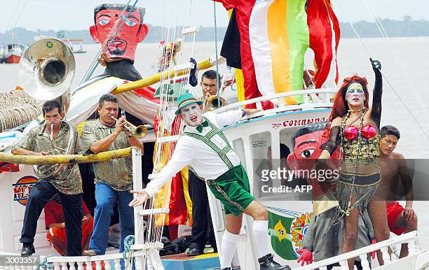 Revelers belonging to the Fofo de Belem Carnival Band perform on board a typical amazonic boat, 22 February, 2004 during a nautical carnival parade...