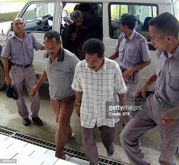 Prison officers escort former Indonesian militias member in East Timor Jose da Costa , Inacio de Oliviera , Miquel Mau and Gilberto Fernandez in to...