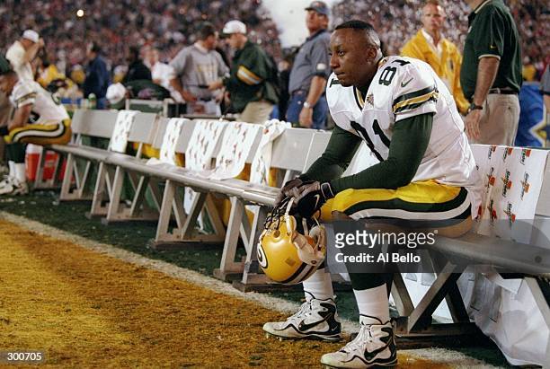 Tyrone Davis of the Green Bay Packers sits on the bench dejected during Super Bowl XXXII against the Denver Broncos at Qualcomm Stadium in San Diego,...
