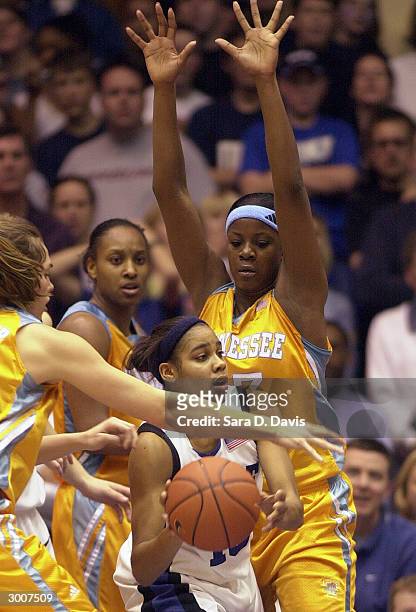 Lindsey Harding of the Duke Blue Devils looks to pass the ball against Tasha Butts and Sidney Spencer of the Tennessee Lady Vols during the game on...