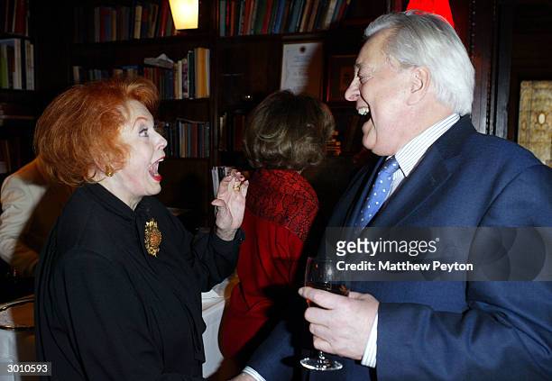 Actress Arlene Dahl enjoys a laugh with Author Robert Osborne at The New York Oscar Party Tasting at Le Cirque 2000 February 24, 2004 in New York...