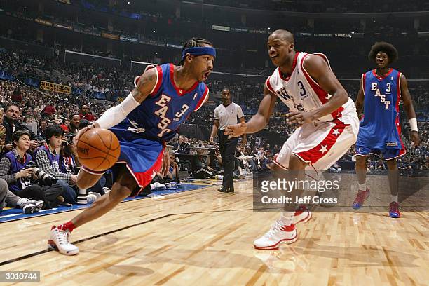 Allen Iverson of the Eastern Conference All-Stars drives around Steve Francis of the Western Conference All-Stars during the 2004 NBA All-Star Game,...