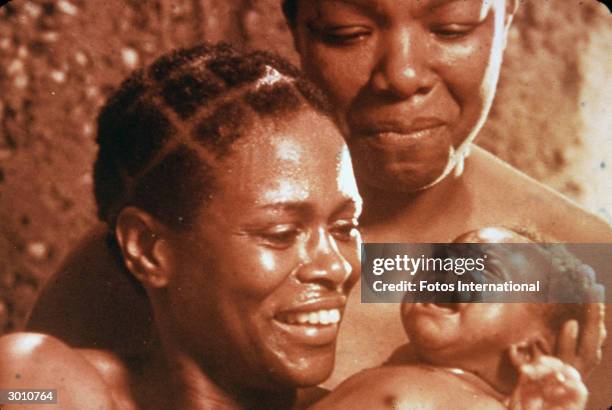 American actors Cicely Tyson and Maya Angelou look lovingly at a baby in a scene from the television mini series 'Roots,' directed by Marvin J....