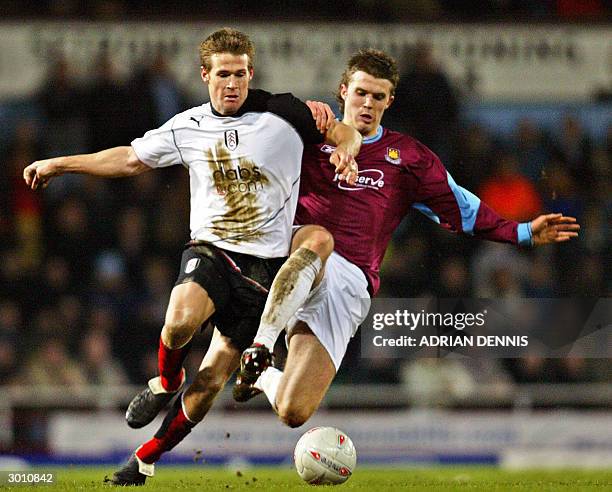 Fulham's Brian McBride fights for the ball with Michael Carrick of West Ham during the F.A. Cup 5th Round Replay football match at Upton Park in...