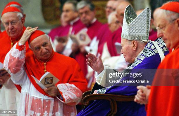 Pope John Paul II waves to the Cardinals as he arrives at St. Peter?s Basilica to celebrate the blessing and the imposition of the ashes February 25,...