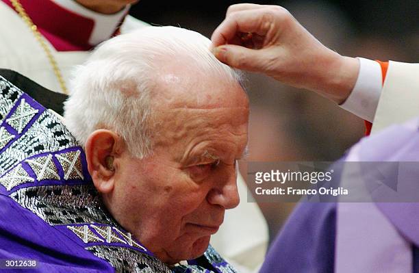 Pope John Paul II receives the imposition of the ashes at St. Peter?s Basilica from Cardinal Angelo Sodano during the Ash Wednesday Service February...