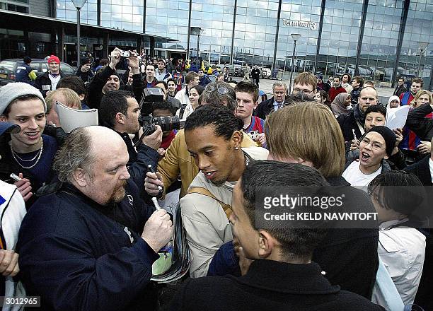 Barcelona's Ronaldinho is welcomed by fans, as his team arrives at Copenhagen airport 25 February, 2004 on the eve of his team's UEFA match against...