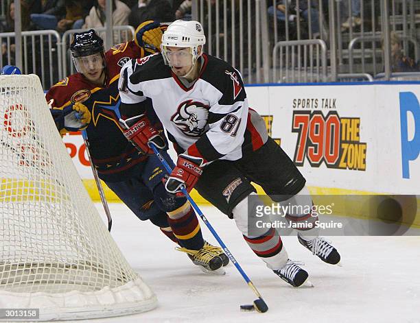 Miroslav Satan of the Buffalo Sabres moves the puck from behind the net against the Atlanta Thrashers at Philips Arena on January 20, 2004 in...