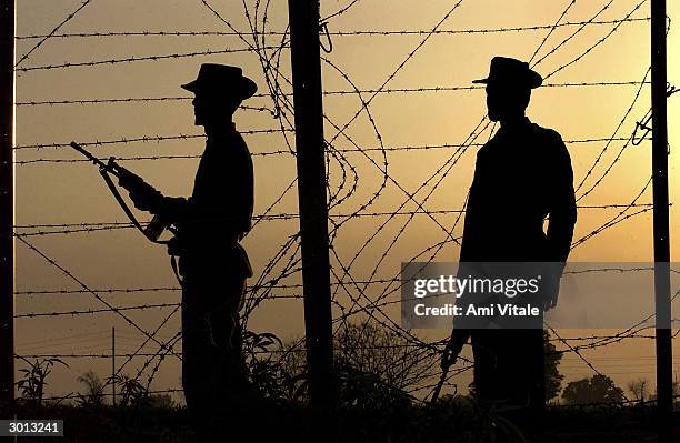 Indian Border Security constables patrol along the International Border where a fence seperating India and Pakistan is being built on February 25,...