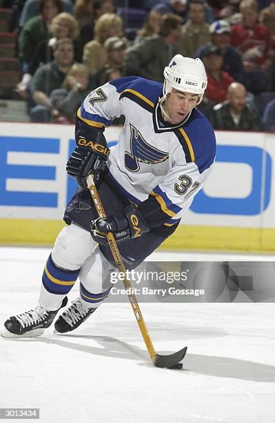 Defender Jeff Finley of the St. Louis Blues advances the puck against the Phoenix Coyotes during the game at America West Arena on November 19, 2003...