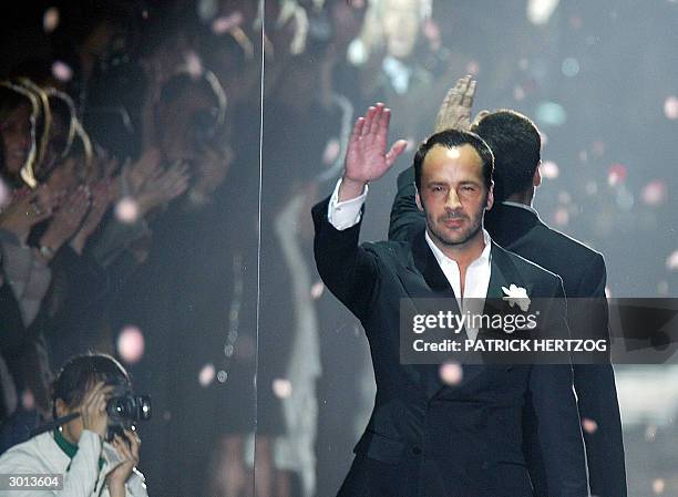 Designer Tom Ford aknowledges applauses on the catwalk at the end of his last Gucci Autumn/Winter 2004-2005 women' collection during Milan fashion...