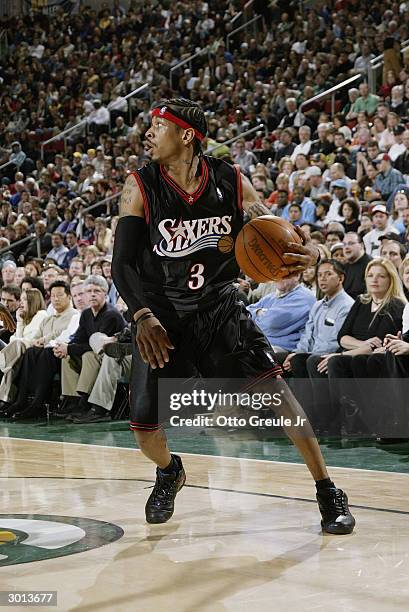 Allen Iverson of the Philadelphia 76ers dribbles the ball against the Seattle Sonics during the game on February 19, 2004 at Key Arena in Seattle,...