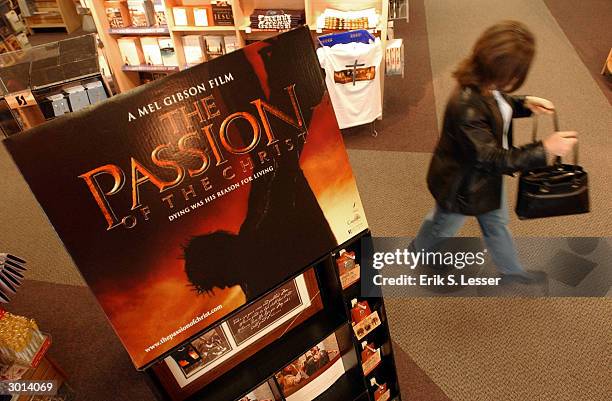 Shoppers walks past a "The Passion of the Christ" merchandise display at Family Christian Stores in Atlanta, Georgia, February 25, 2004. The...