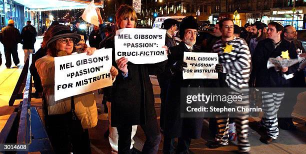 Demonstrators hold signs protesting Mel Gibson's The Passion of the Christ outside a movie theater February 25, 2004 in New York CIty.'The Passion of...