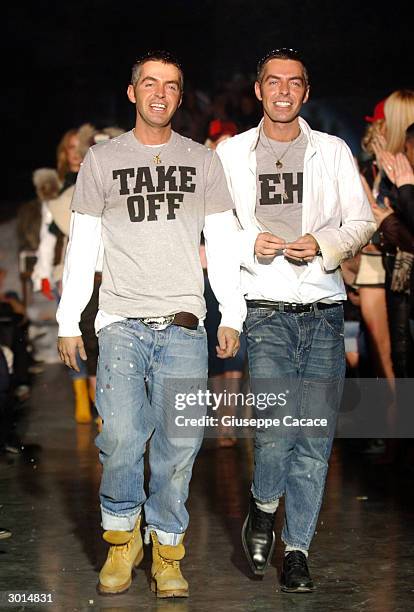 Canadian designers Dean and Dan Caten acknowledge the applause at the end of their DSQUARED2 Autumn/Winter women's collection 2004/2005, on February...