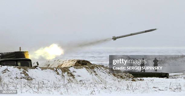 Missile launched from the Soviet made rocket system BM-21, "Grad", flies above running soldiers during military exercises of Ukraine's army on...