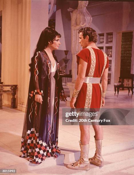 Married actors Elizabeth Taylor and Richard Burton stand in costume as Cleopatra and Marc Antony in a still from the film, 'Cleopatra,' directed by...