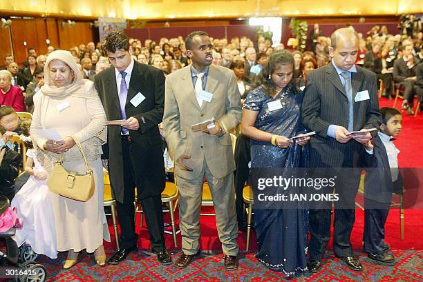 London, UNITED KINGDOM: New British citizens take part in the first citizenship ceremony at Brent Town Hall in London 26 February, 2004. Charles, the...