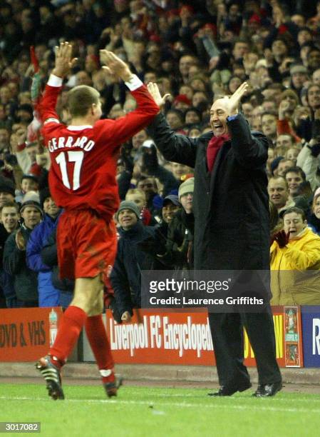 Steven Gerrard of Liverpool celebrates with manager Gerard Houllier after scoring the first goal during the UEFA Cup third round first leg match...