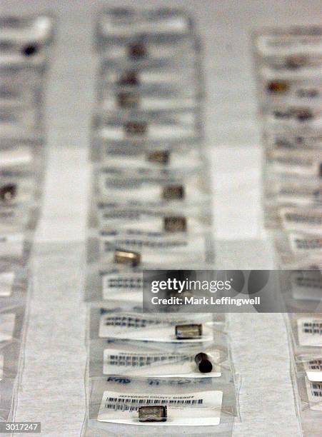 Hundreds of shell casings are shown bagged individually and laid out on tables marking what part of Columbine High School they were collected from...