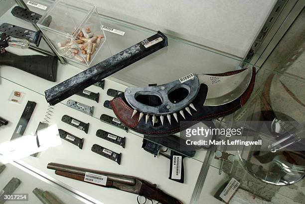 Several weapons carried by Eric Harris and Dylan Klebold, including a large knife with a spiked knuckle guard, are shown on display at the Jefferson...