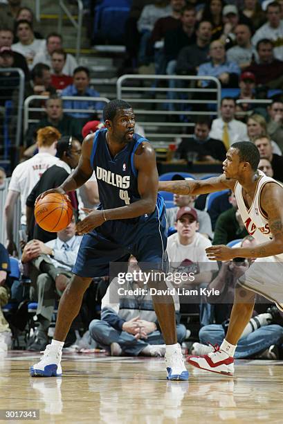 Michael Finley of the Dallas Mavericks is defended by Dajuan Wagner of the Cleveland Cavaliers during the game at Gund Arena on February 18, 2004 in...