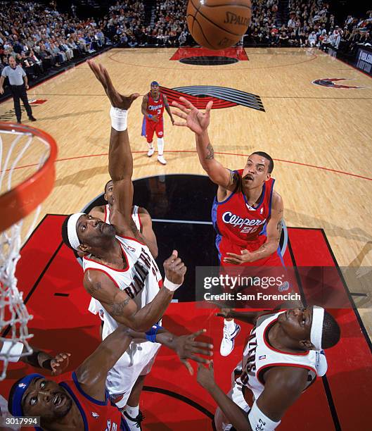 Matt Barnes of the Los Angeles Clippers puts up a shot over Dale Davis and of the Portland Trail Blazers during the game at The Rose Garden on...