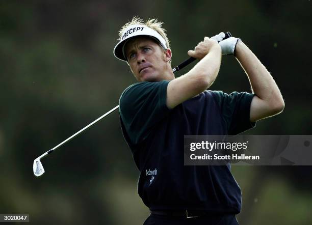 Stuart Appleby of Australia hits his tee shot on the 12th tee during his second round match with Chris DiMarco at the WGC- Accenture Match Play...