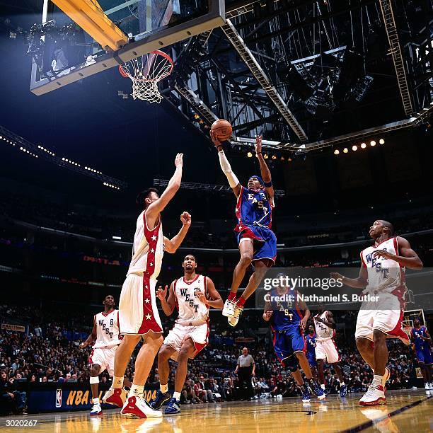 Allen Iverson of the Eastern Conference All-Stars shoots against Yao Ming of the Western Conference All-Stars during the 2004 All-Star Game on...