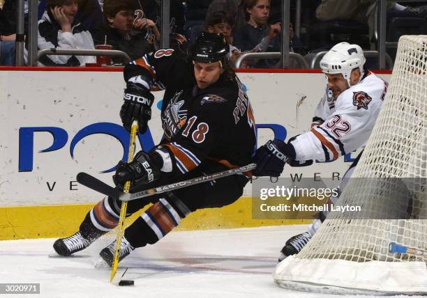 Matt Pettinger of the Washington Capitals tries for the backhand wrap-around past Scott Ferguson of the Washington Capitals during the game at MCI...