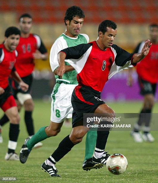 Al-Rayan's Algerian star Ali Benarbia is challenged by Spain's Josep Guardiola of al-Ahli during their Qatari league match at al-Rayan stadium in...