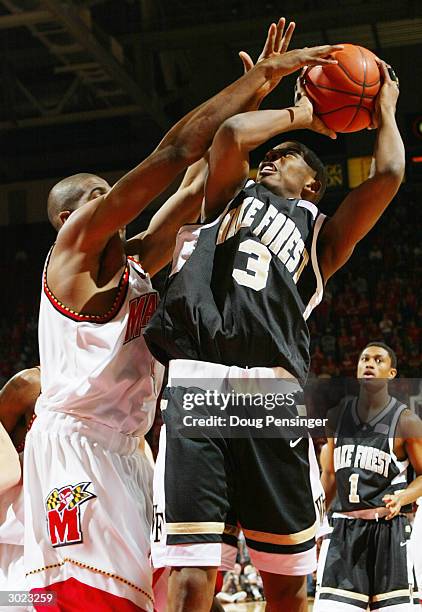 Chris Paul of the Wake Forest Demon Deacons gets off a shot in the face of the defense of Travis Garrison of the Maryland Terrapins as the Deacons...