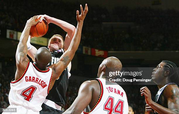 Vytas Danelius of the Wake Forest Demon Deacons has his shot blocked by Travis Garrison of the Maryland Terrapins as the Demon Deacons defeated Terps...