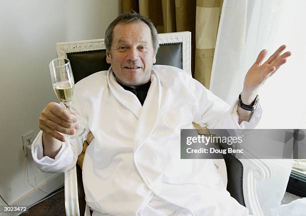 World renowned chef Wolfgang Puck enjoys a glass of champagne whle soaking his feet in Perrier Jouet 1993 Fleur de Champagne and rose petals while...