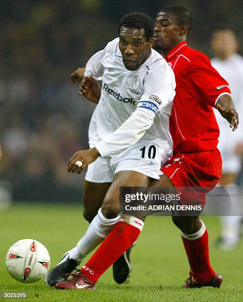 Bolton's Jay Jay Okocha collides with Middlesbrough's George Boateng as they fight for the ball during the Carling Cup Final football match 29...