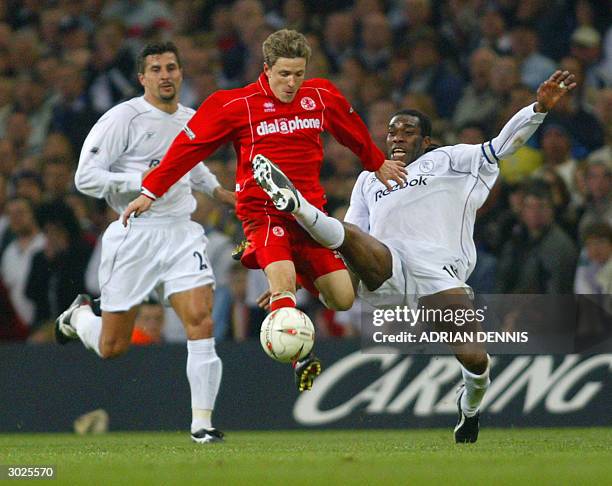 Middlesbrough's Juninho breaks past a tackle by Bolton's Jay Jay Okocha as his teammate Emerson Thome watches during the Carling Cup Final football...