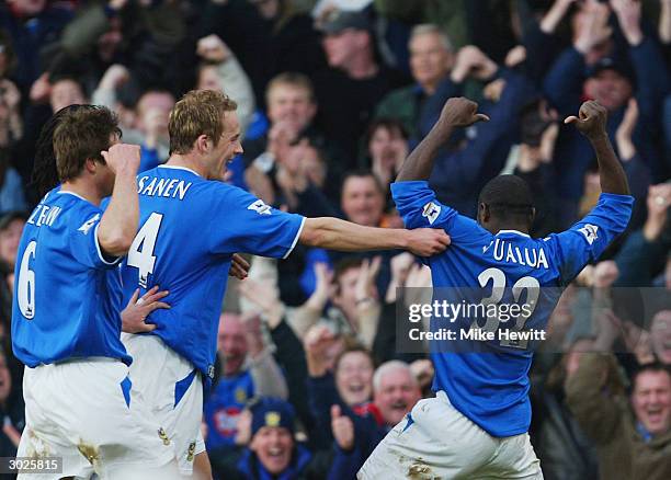 Lomana LuaLua of Portsmouth points to his name as he celebrates scoring his goal during the FA Barclaycard Premiership match between Portsmouth and...