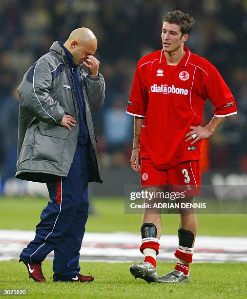 Middlesbrough's Franck Queudrue speaks with reserve teammate Massimo Maccarone after the Carling Cup Final football match against Bolton 29 February,...